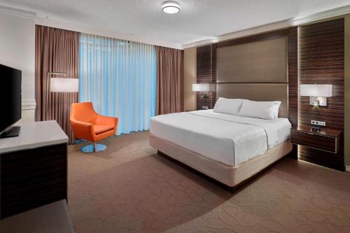 a bedroom with a bed and a desk and a chair at Delta Hotels by Marriott Edmonton Centre Suites in Edmonton