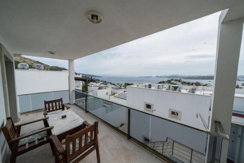 a balcony with a table and chairs and a view at Ilya Apart 1 in Bodrum City