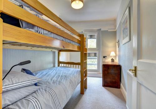 a bedroom with two bunk beds and a lamp at 6 St Saviours Lane in Padstow