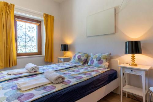 ein Schlafzimmer mit einem Bett mit Handtüchern darauf in der Unterkunft Il Giardino ai Volti 1T, Caldonazzo Ospitar in Caldonazzo