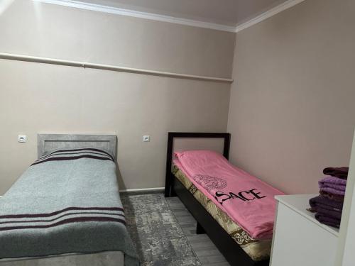 a bedroom with two twin beds in it at Pamko in Naryn