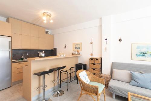 a kitchen and living room with a couch and a table at Houseloft Grand Sunset Siviri Beach in Siviri