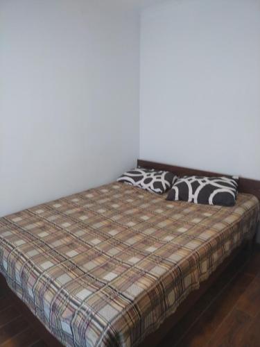 a bed with two pillows on it in a room at Пансионат Сабрина in Bosteri