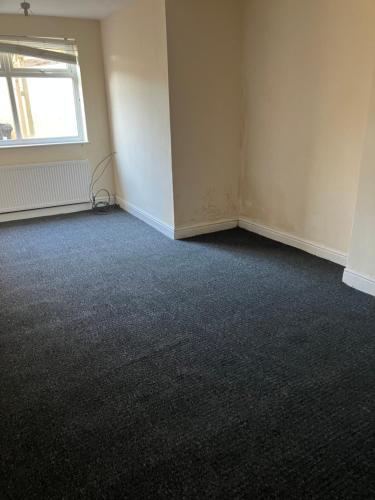 a room with an empty room with a window at Astley House - Manchester in Dukinfield