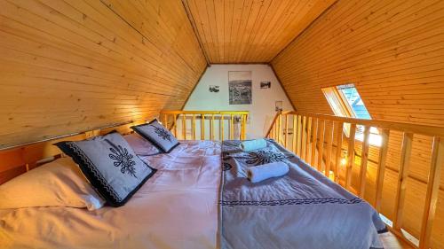 a bedroom with a bed in a wooden cabin at Apartamenty Pod Cisówką in Zakopane