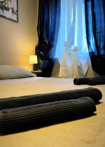 a bedroom with a bed with a blanket and a window at La Casetta in Montefegatesi