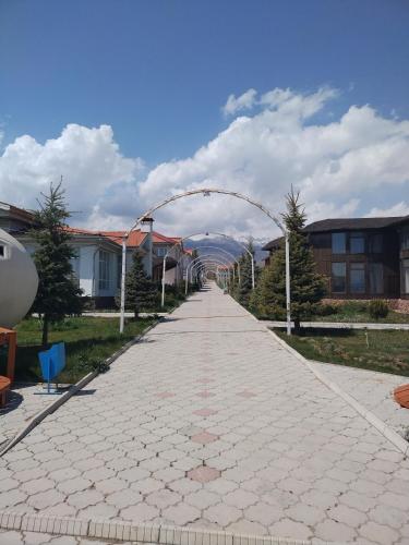 a brick road with an arch in the middle at Пансионат Сабрина in Bosteri