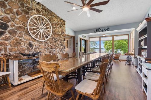 a large dining room with a large stone wall at Red Bud Cove Lakefront Farm House on Table Rock Lake in Hollister