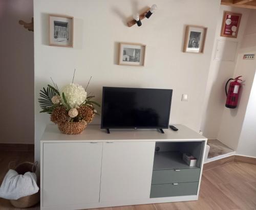 a white entertainment center with a flat screen tv on it at Amieira do Tejo guest house in Barca da Amieira