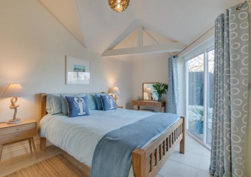 a bedroom with a large bed and a window at Chy Vean in Padstow
