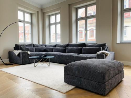 a living room with a couch and a table and windows at Luxury Home / 3-Raum-Suite an der Frauenkirche / 6 in Dresden