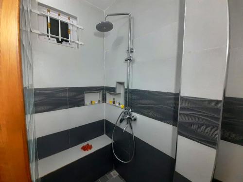 a bathroom with a shower with a glass door at Cosy Villa in Pointe aux Piments with Shared Pool. in Pointe aux Piments
