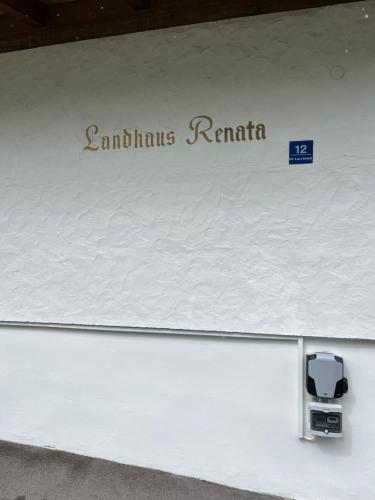 a sign that says santa fe roma on a white wall at Landhaus Renata Bayrischzell in Bayrischzell