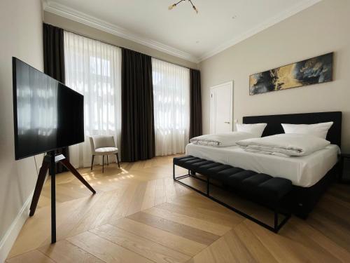 a bedroom with a bed and a flat screen tv at Luxury Home / 3-Raum-Suite an der Frauenkirche / 6 in Dresden