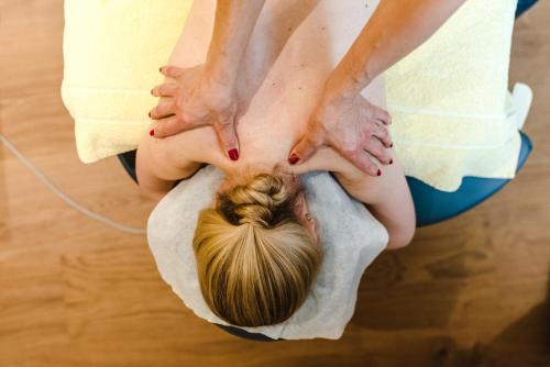 a woman getting aorative massage on the floor at Aktiv Hotel & Spa Hannigalp in Grächen
