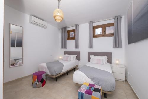 En eller flere senge i et værelse på Villa Bethany