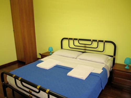 a bedroom with a bed with two towels on it at Star Hostel in Milan