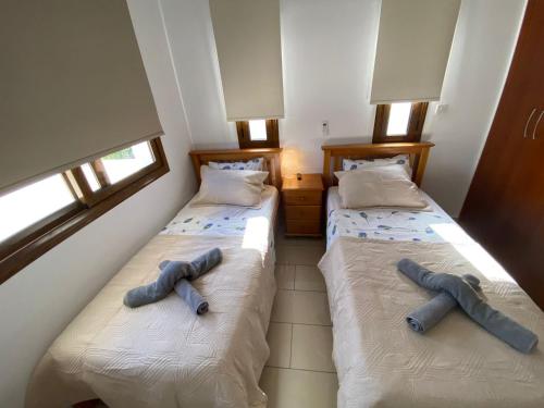 two beds sitting next to each other in a room at Villa Angel - Exotic Villa 200m From Beach in Paralimni