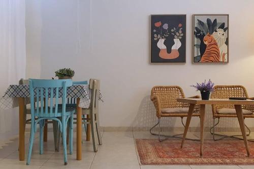 comedor con sillas azules y mesa en נקודת חן, en Shadmot Devora
