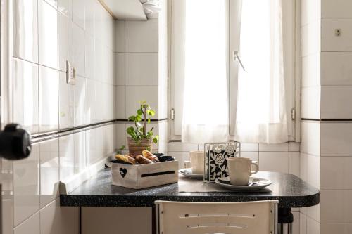a kitchen with a table with a bowl of food on a counter at Dulcis In Colosseo Apartments in Rome