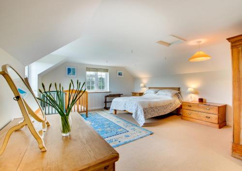 a bedroom with a bed and a wooden dresser at Cross House in Saint Issey