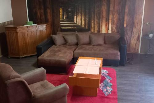 a living room with a couch and a coffee table at Kod Komse in Srbobran