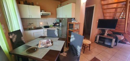 a small kitchen with a table and a television at Apartment Balatonfenyves/Balaton 26709 in Balatonfenyves