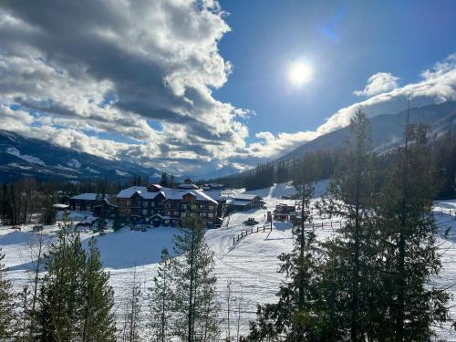 a ski resort in the snow with trees and mountains at Snow Creek Lodge by Fernie Central Reservations in Fernie