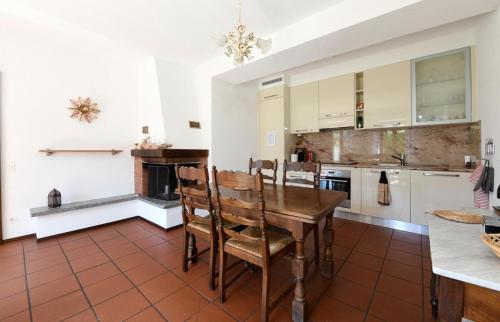 an open kitchen with a wooden table and chairs at The Lake Garden 1 in Caslano