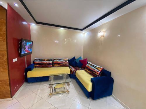 a room with two beds and a tv in it at appartement luxueux à Rabat in Sale