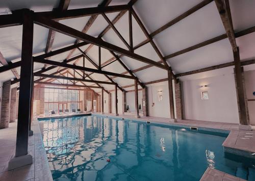 a large swimming pool with a large ceiling at Cave Castle Hotel in South Cave