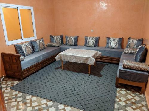 a living room with a couch and a table at la hinshada place in Agadir