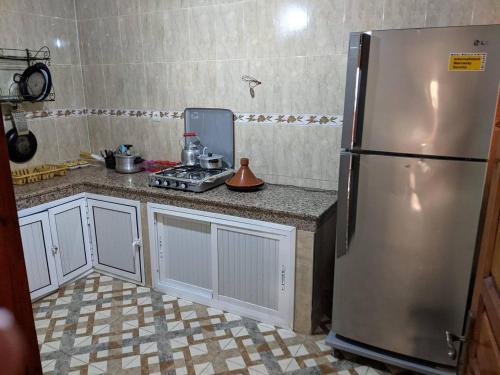 a kitchen with a stainless steel refrigerator at la hinshada place in Agadir
