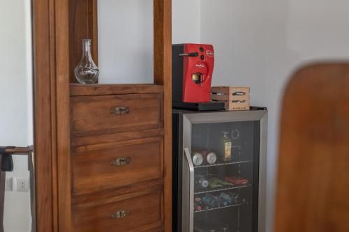 a wooden cabinet next to a small refrigerator at Dimora Morello in Poggio Morello