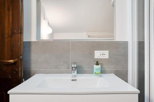 a bathroom with a white sink and a mirror at Il Cirmolo in Madonna di Campiglio