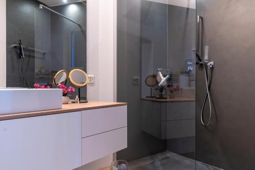 a bathroom with a shower and a sink and a mirror at Orselina in Style in Orselina