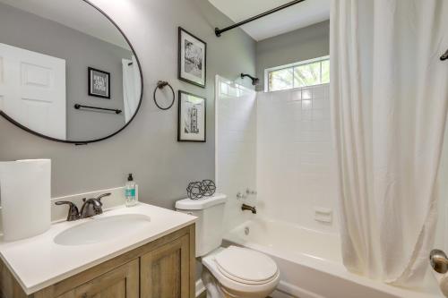 a bathroom with a sink and a toilet and a mirror at Decatur Vacation Rental with Fenced Yard! in Decatur