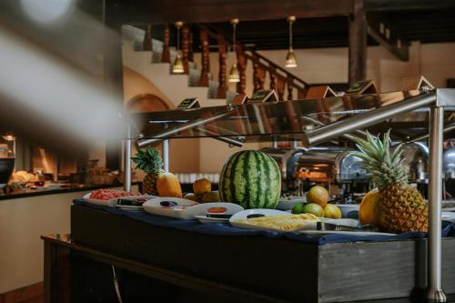 a buffet with fruits and vegetables on a table at Parador Nature Resort and Spa in Manuel Antonio