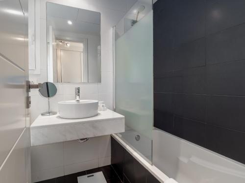a white bathroom with a sink and a mirror at 2051-New 3 bedrooms on golf in Estepona