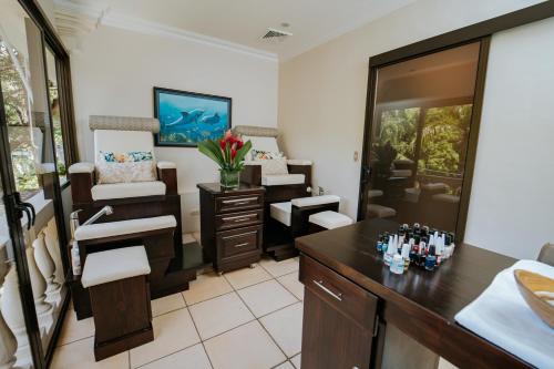 a room with a salon with a vanity and chairs at Parador Nature Resort and Spa in Manuel Antonio