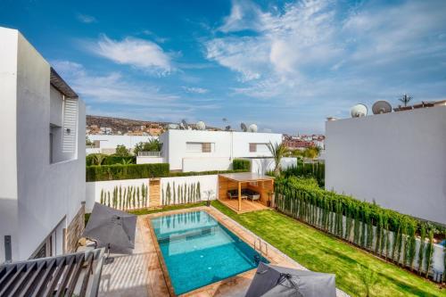 an image of a house with a swimming pool at Theme - Taghazout - Luxury villa - 10 Px in Taghazout