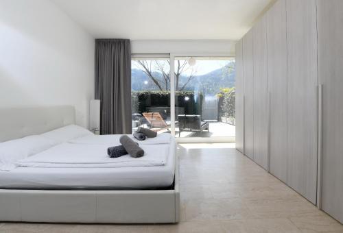 a bedroom with a bed and a view of a patio at The Minimal House & SPA in Caslano