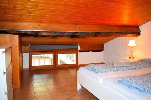 a bedroom with two beds and a wooden ceiling at Il Rustico 2 in Castel San Pietro