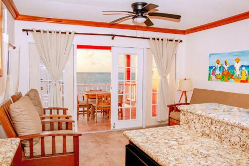 a living room with a view of the ocean at Mayan Princess Hotel in San Pedro