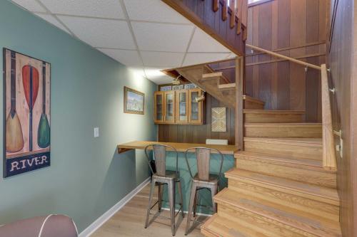 a staircase in a house with a table and chairs at Mountaintop Mars Hill Cabin with Wraparound Deck! in Swiss
