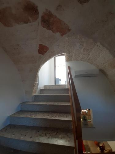 a staircase in a building with a stone ceiling at LA CASETTA in puglia in Montalbano