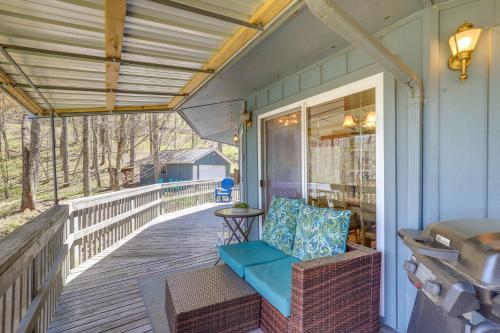 a porch with a bench and a table at Mountaintop Mars Hill Cabin with Wraparound Deck! in Swiss