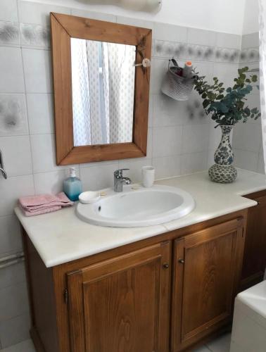 a bathroom with a sink and a mirror at FYKIA HOUSE in Naousa