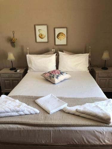 a bed with two towels sitting on top of it at FYKIA HOUSE in Naousa