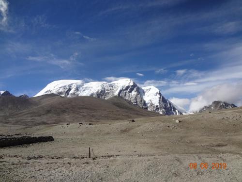 a snow covered mountain in the middle of a field at The Bliss Homestay in Gangtok